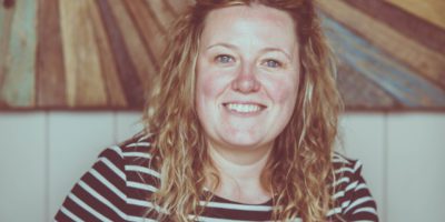 Cat Roberts-Young, copywriter, in a black and white stripy top.